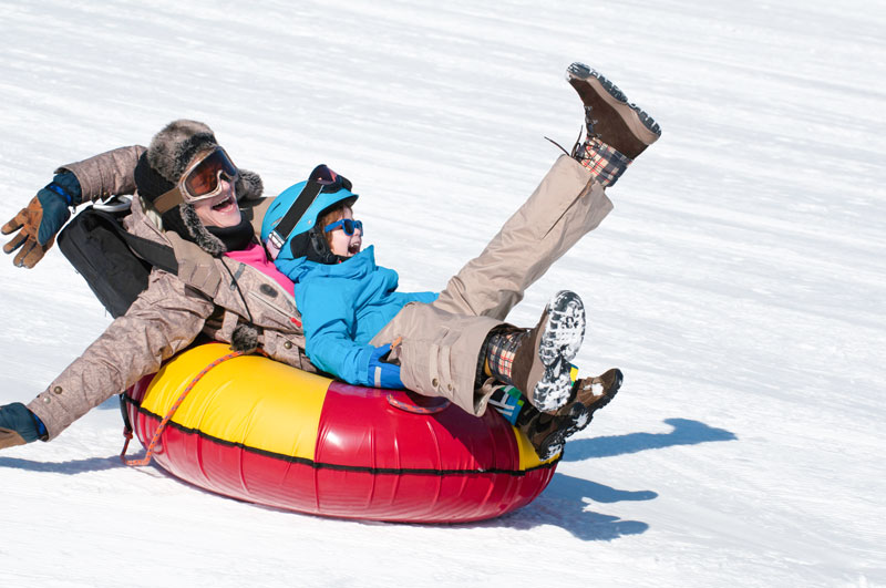 Father and son tubing down the hill